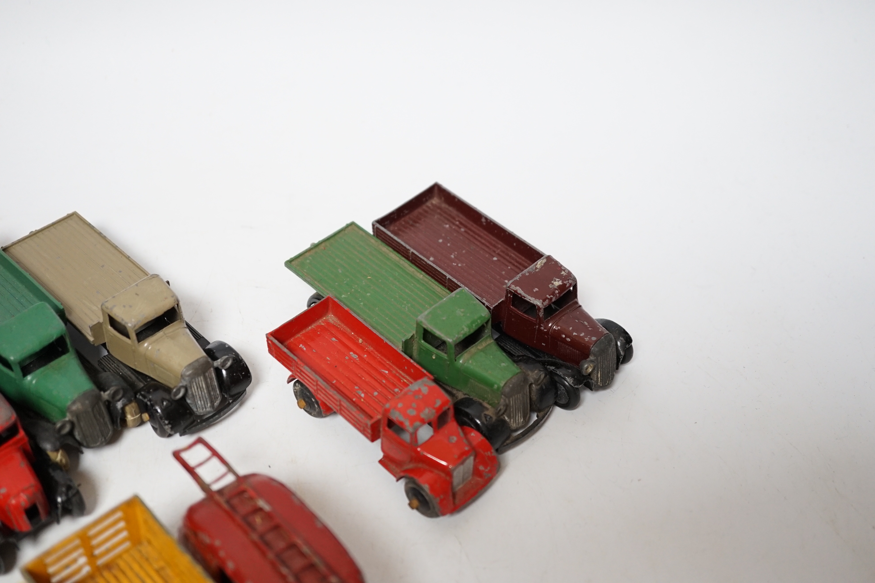 Twenty-five Dinky Toys and Atlas Dinky including a few pre-war examples; Delivery lorries, Market Gardener’s wagon, a Streamlined Fire Engine, a Jaguar SS, Mechanical Horse, etc. together with five Atlas stinky, includin